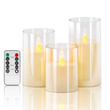Set of three flameless candles with a remote control on a white background